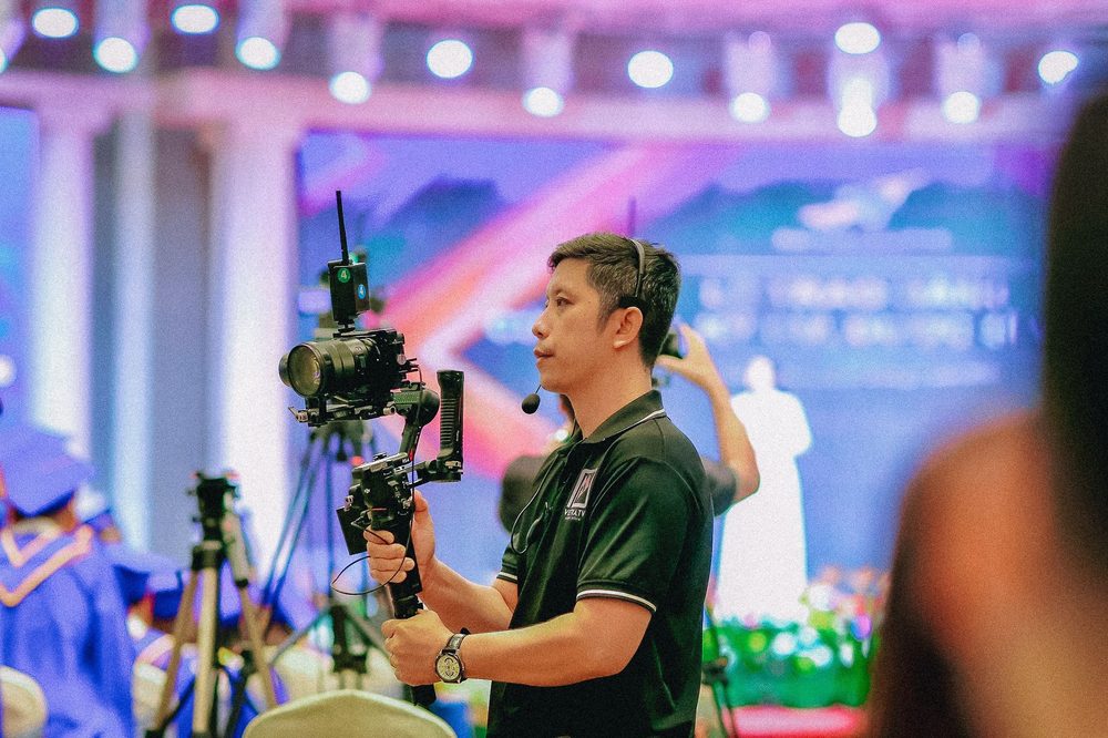 Videógrafo grabando un evento de empresa con estabilizador